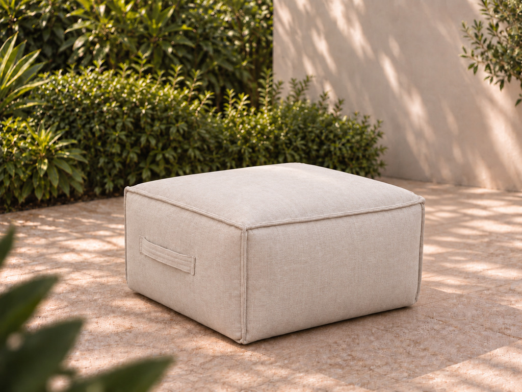 Cove Ottoman in Cashmere Sunbrella fabric on a garden terrace