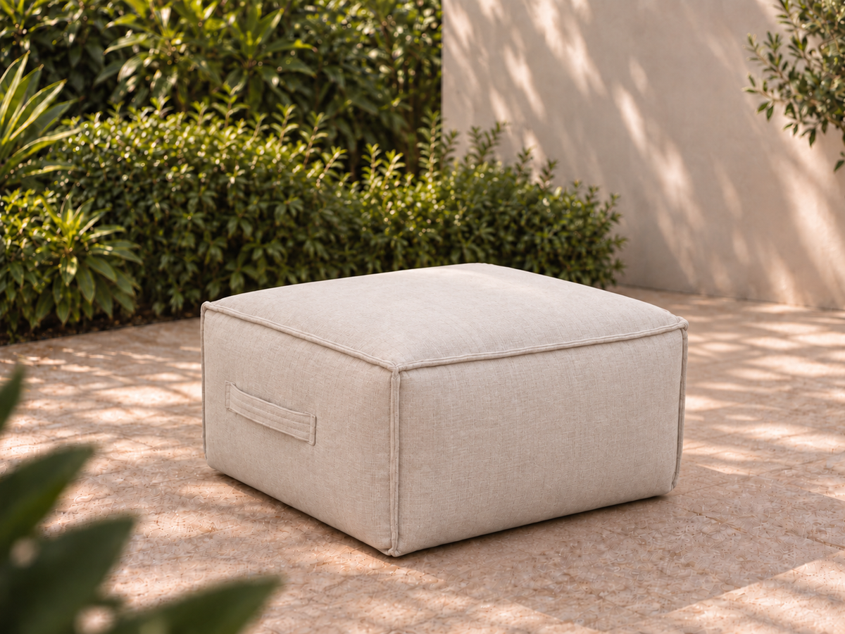 Cove Ottoman in Cashmere Sunbrella fabric on a garden terrace