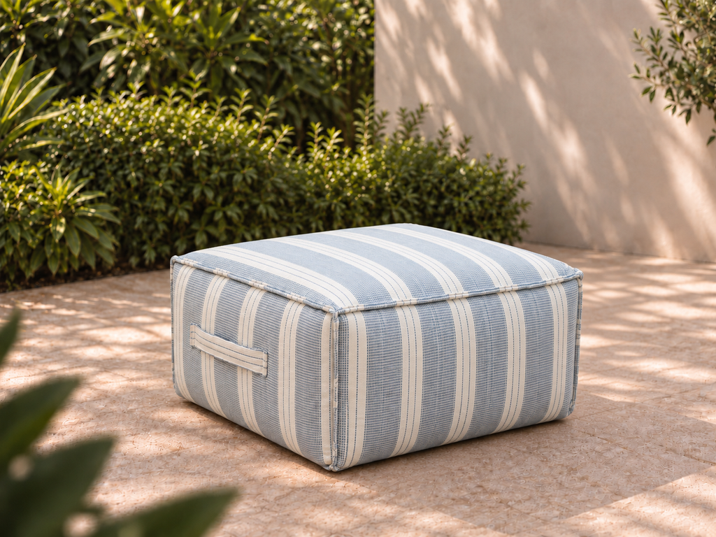 Cove Ottoman in Dobby Stripe Sunbrella fabric on a garden terrace