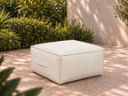 Cove Ottoman in Nurture White Sunbrella fabric on a garden terrace