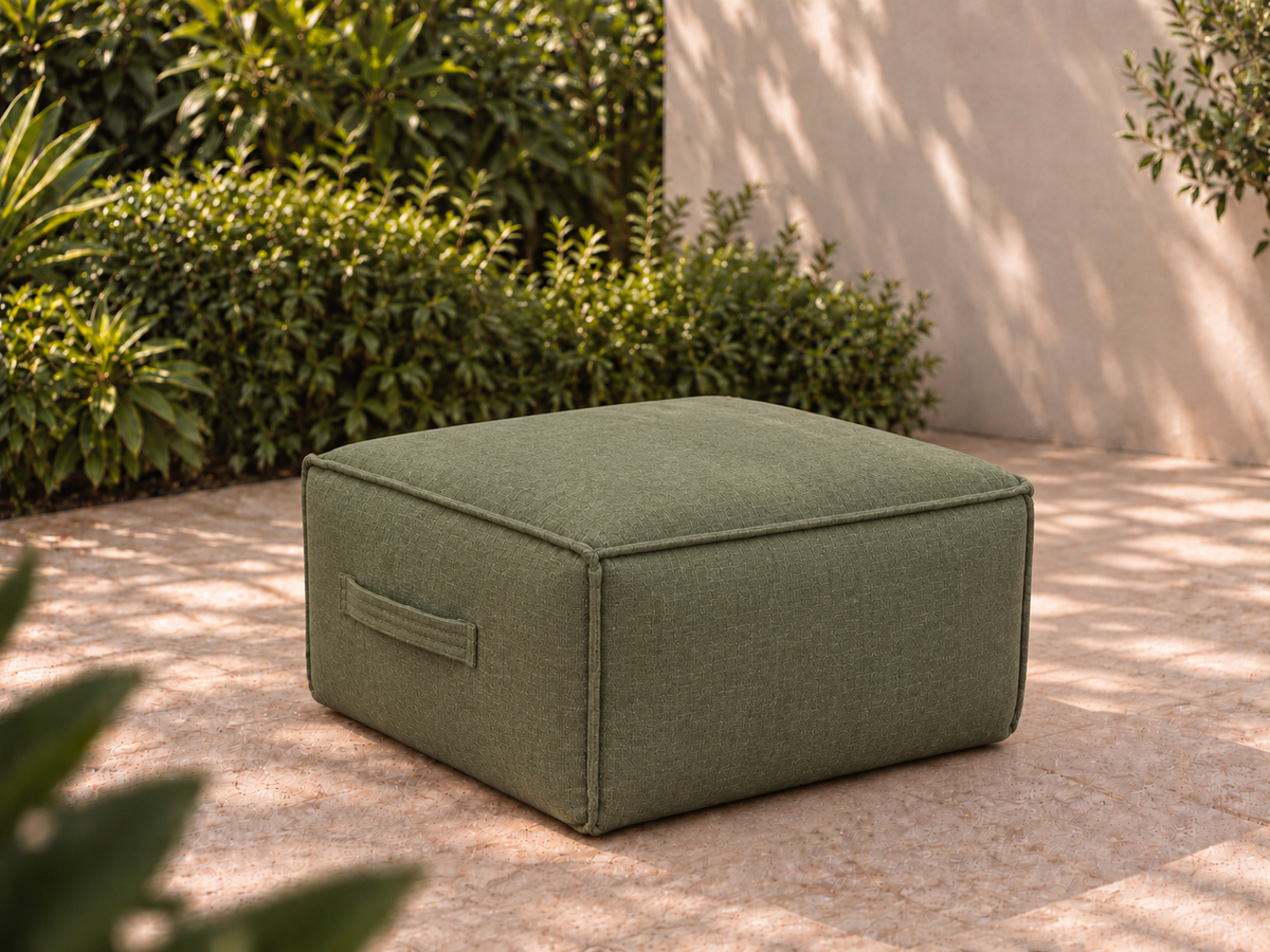 Cove Ottoman in Willa Frond Sunbrella fabric on a garden terrace