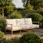 Royal Teak Collection Palma Sofa in White All-Weather Cushions on a Flagstone Garden Patio