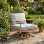 Royal Teak Collection Palma Swivel Chair in Granite All-Weather Cushions on a Flagstone Garden Patio